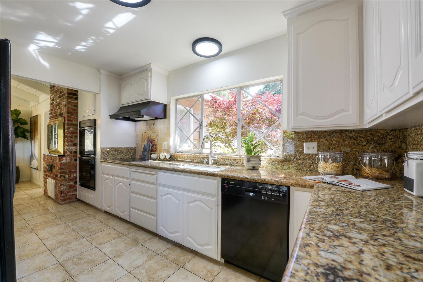 2620 Summit Drive Burlingame, CA 94010 - Photo 11 of 49 a kitchen with stainless steel appliances granite countertop a sink and a stove