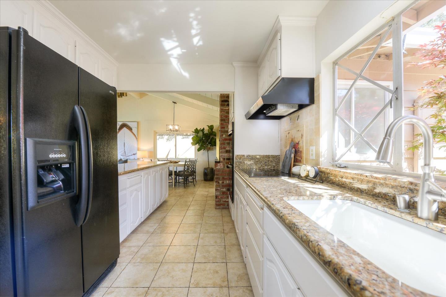 2620 Summit Drive Burlingame, CA 94010 - Photo 12 of 49 a kitchen with stainless steel appliances granite countertop a sink and a refrigerator