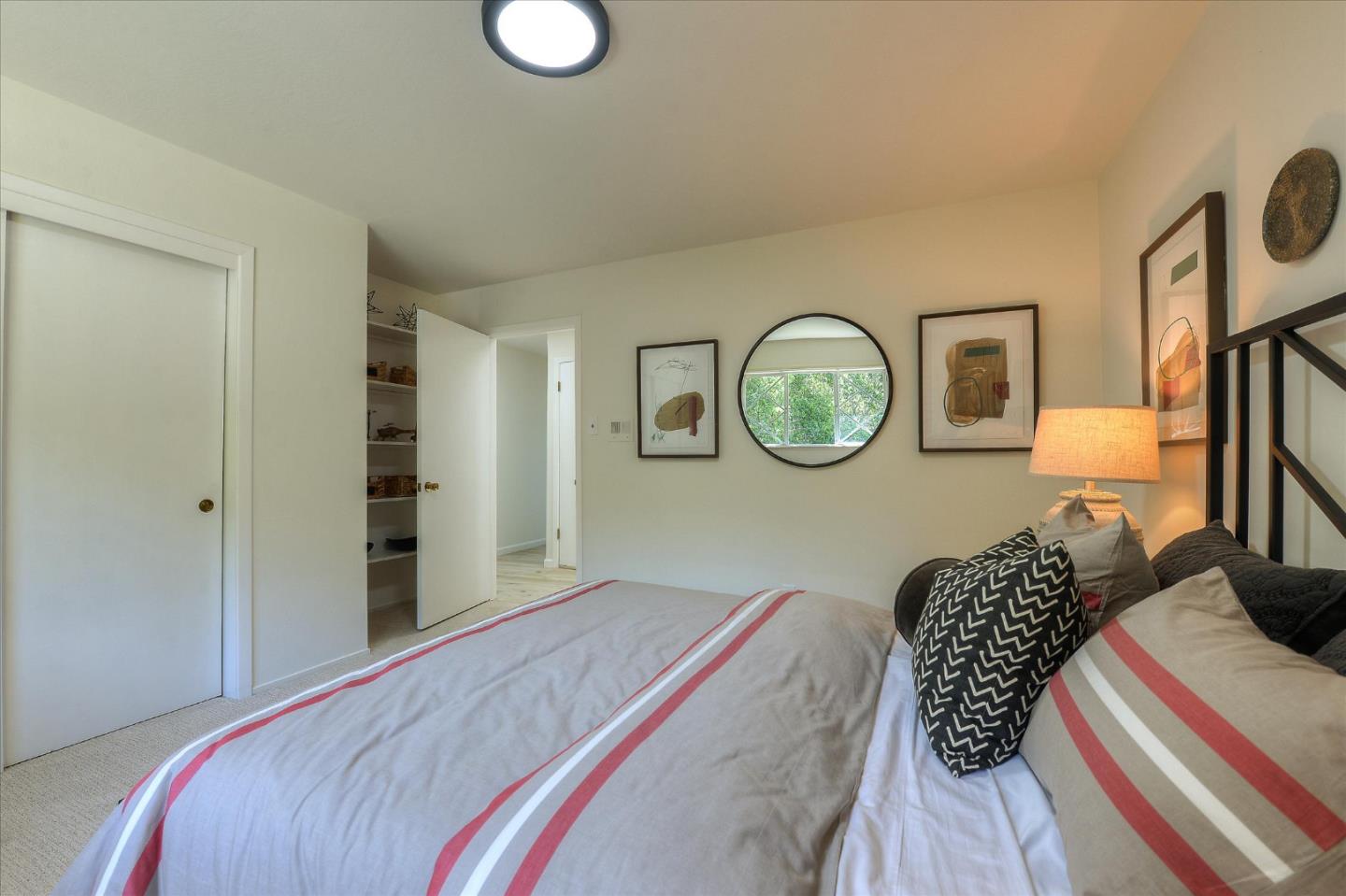 2620 Summit Drive Burlingame, CA 94010 - Photo 28 of 49 a bedroom with a bed a mirror and a window