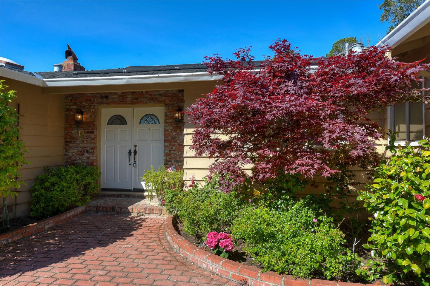 2620 Summit Drive Burlingame, CA 94010 - Photo 3 of 49 a front view of a house with a yard