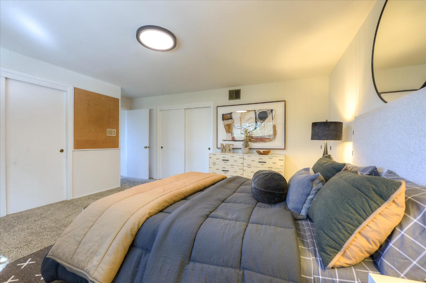 2620 Summit Drive Burlingame, CA 94010 - Photo 40 of 49 a bedroom with a bed and a chandelier