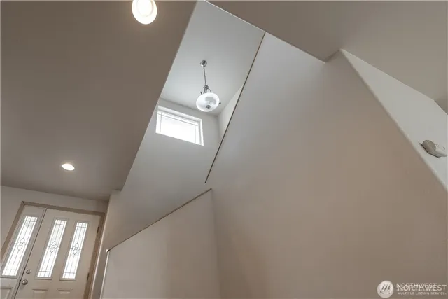 a view of empty room with window and wooden floor