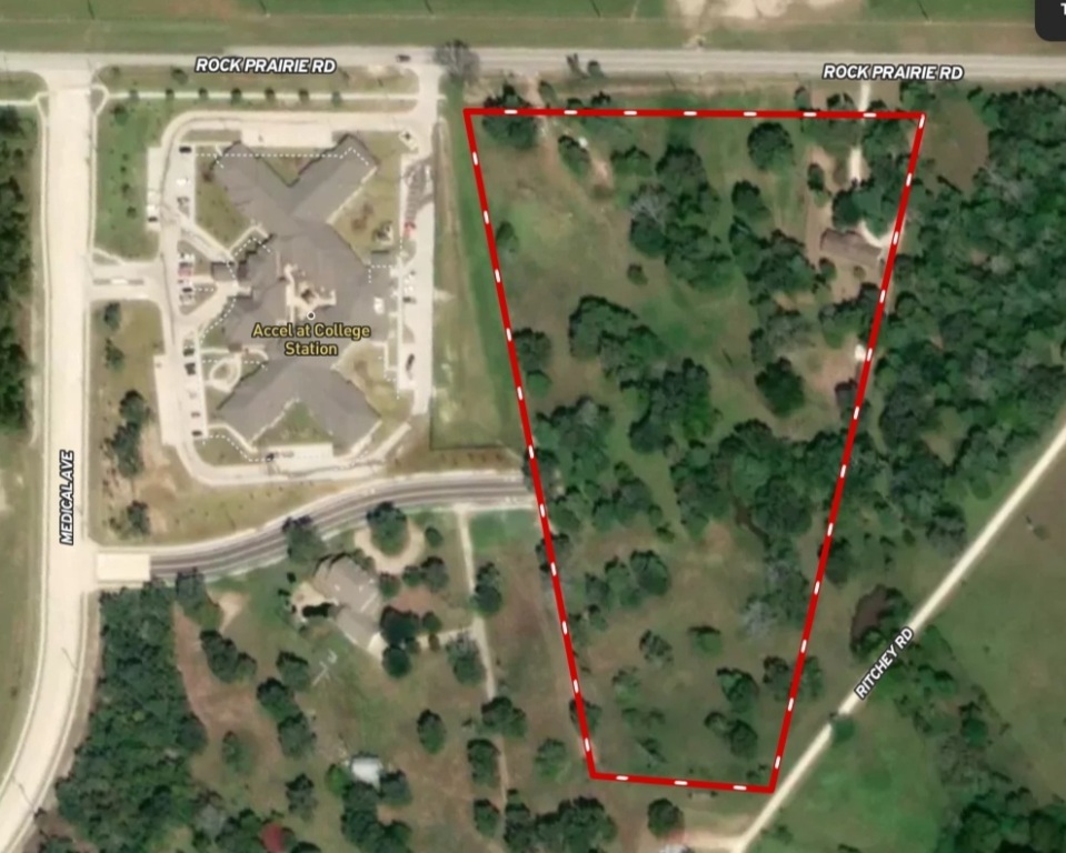 a flower garden in front of a glass door