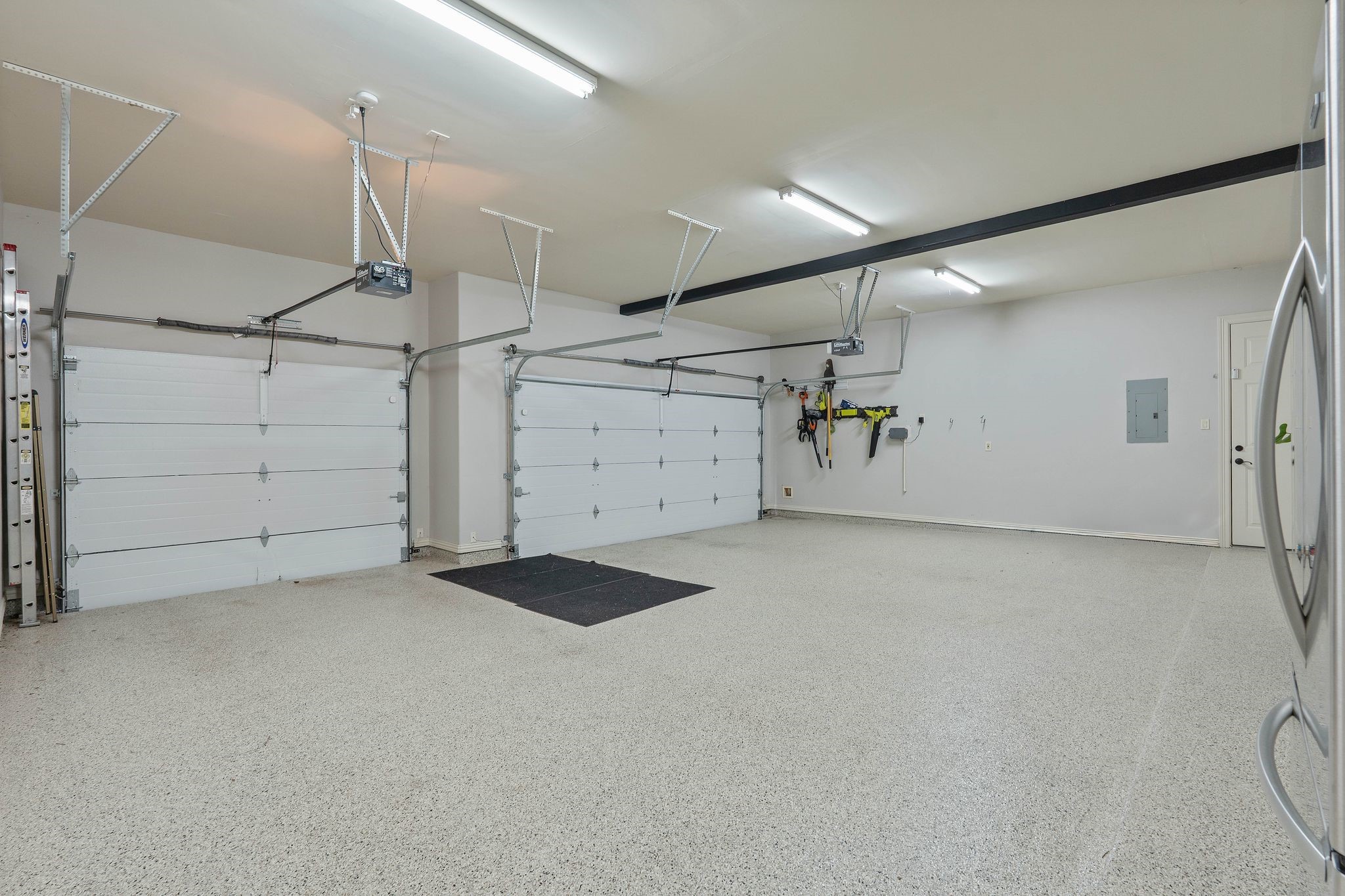 7603 Hogan Bridge Court Spring, TX 77389 - Photo 45 of 50 Spacious three-car garage featuring a durable epoxy-coated floor for a clean, finished look