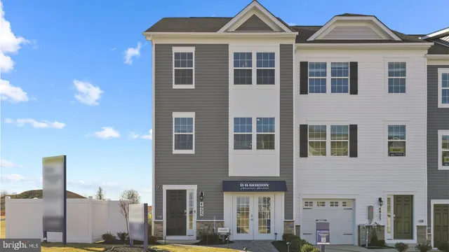 a front view of a residential apartment building with a yard