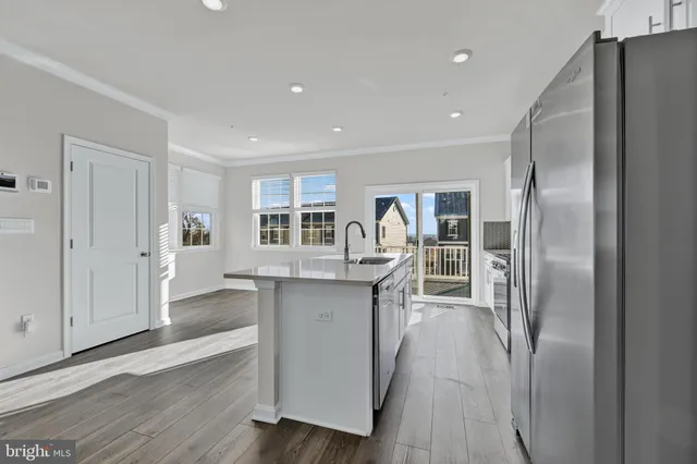 a kitchen with stainless steel appliances granite countertop a refrigerator and a sink