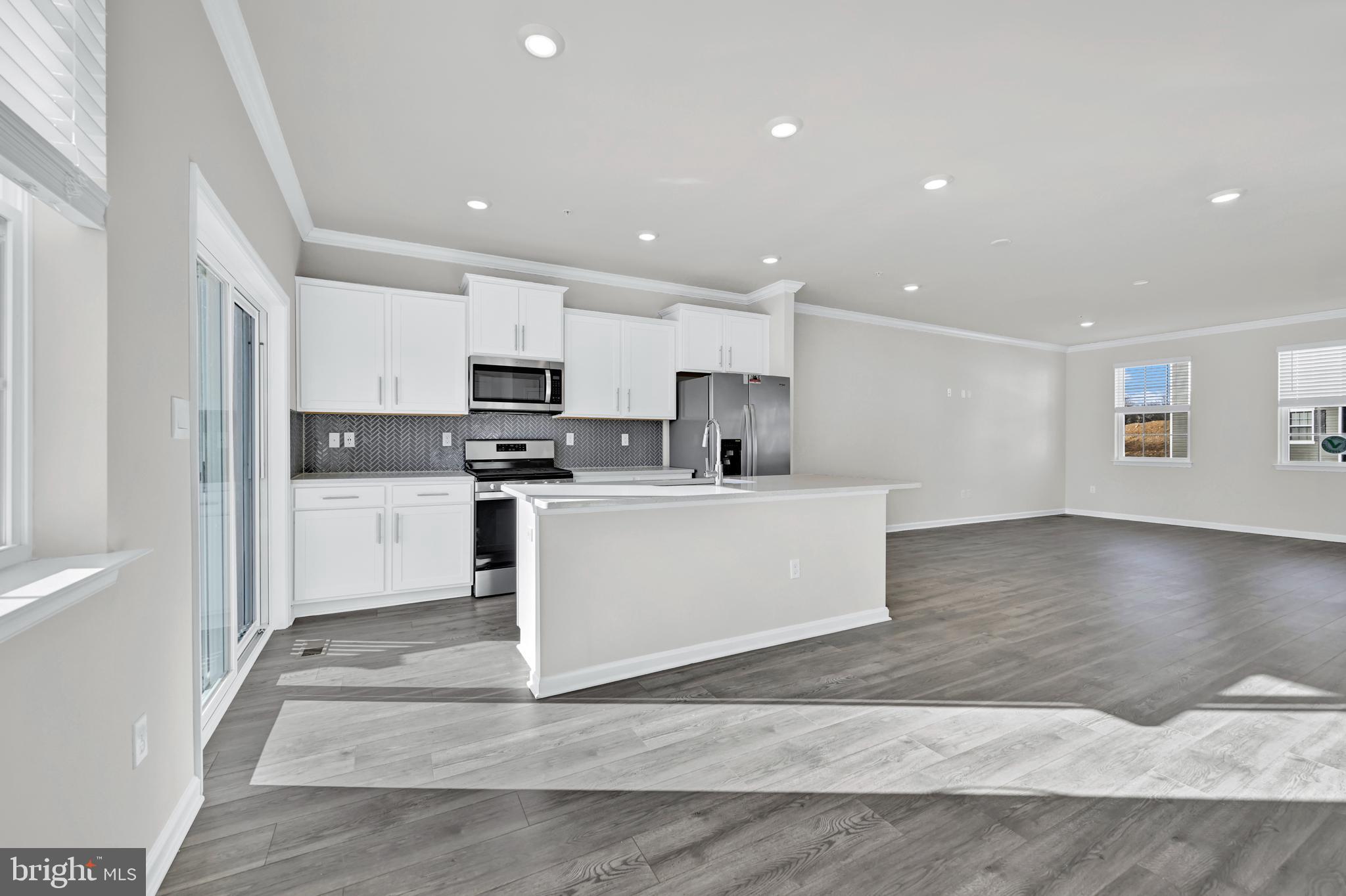 5030 Silver Oak Drive Rosedale, MD 21237 - Photo 13 of 19 a view of kitchen with kitchen island sink refrigerator and white cabinets