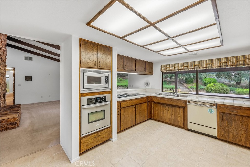 37295 Oak View Road Yucaipa, CA 92399 - Photo 16 of 59 a kitchen with stainless steel appliances granite countertop a refrigerator and a stove top oven