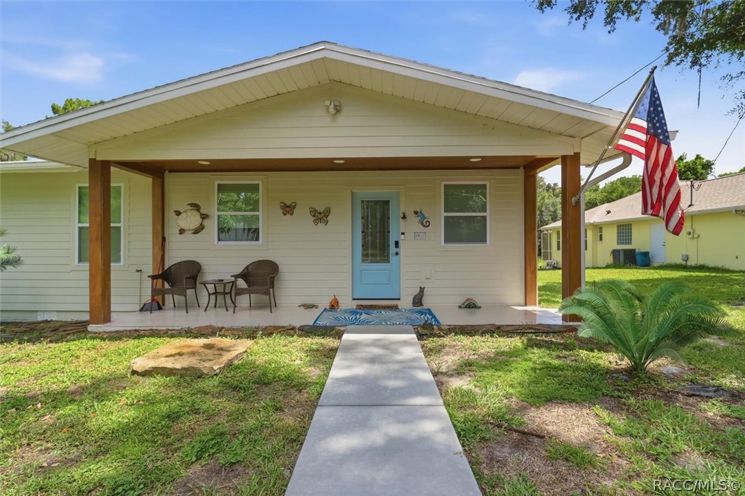 4099 West Ridge Court Dunnellon, FL 34433 - Photo 10 of 49 Another nice view of front porch and paved walkway to front door? God Bless this home and Our Country!