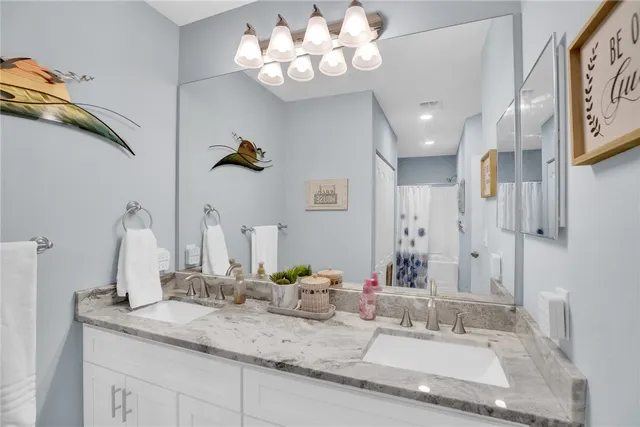 a front view of a multi story residential apartment building with yard and bench