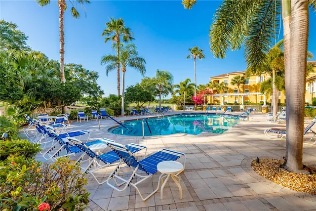 a living room with furniture and large windows