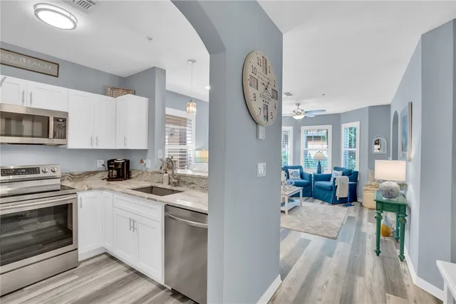 a view of a kitchen with microwave and cabinets
