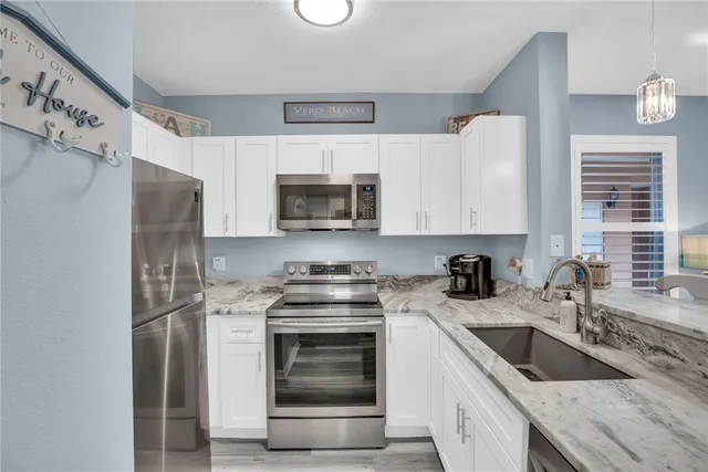 a kitchen with a sink stove and microwave