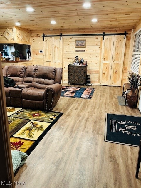 2445 McCord Hill Road Wellsburg, WV 26070 - Photo 21 of 37 Living area featuring a barn door, recessed lighting, wooden ceiling, light wood-style flooring, and wooden walls
