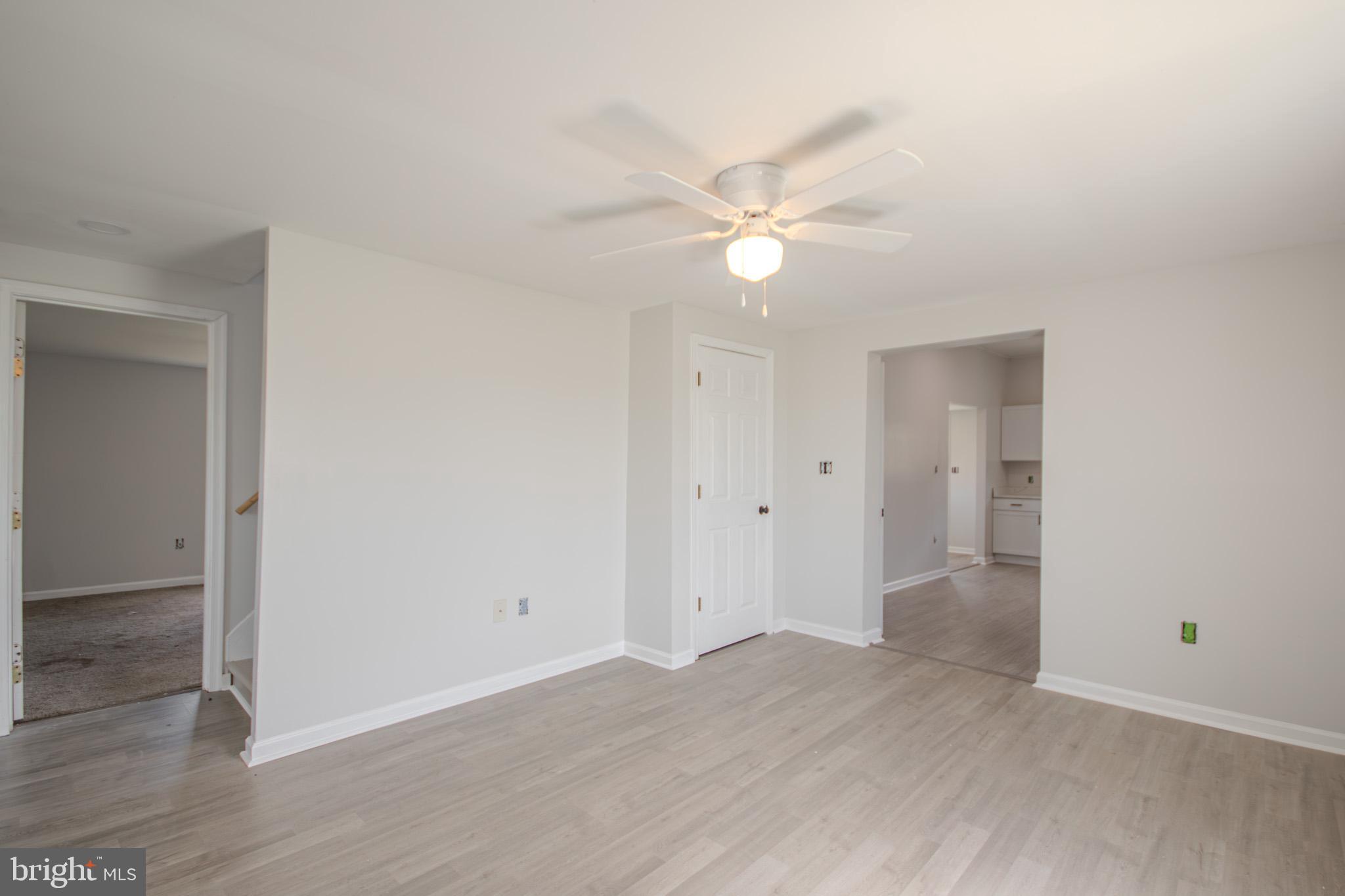 5693 Landon Store Road Marion Station, MD 21838 - Photo 7 of 20 an empty room with wooden floor and ceiling fan