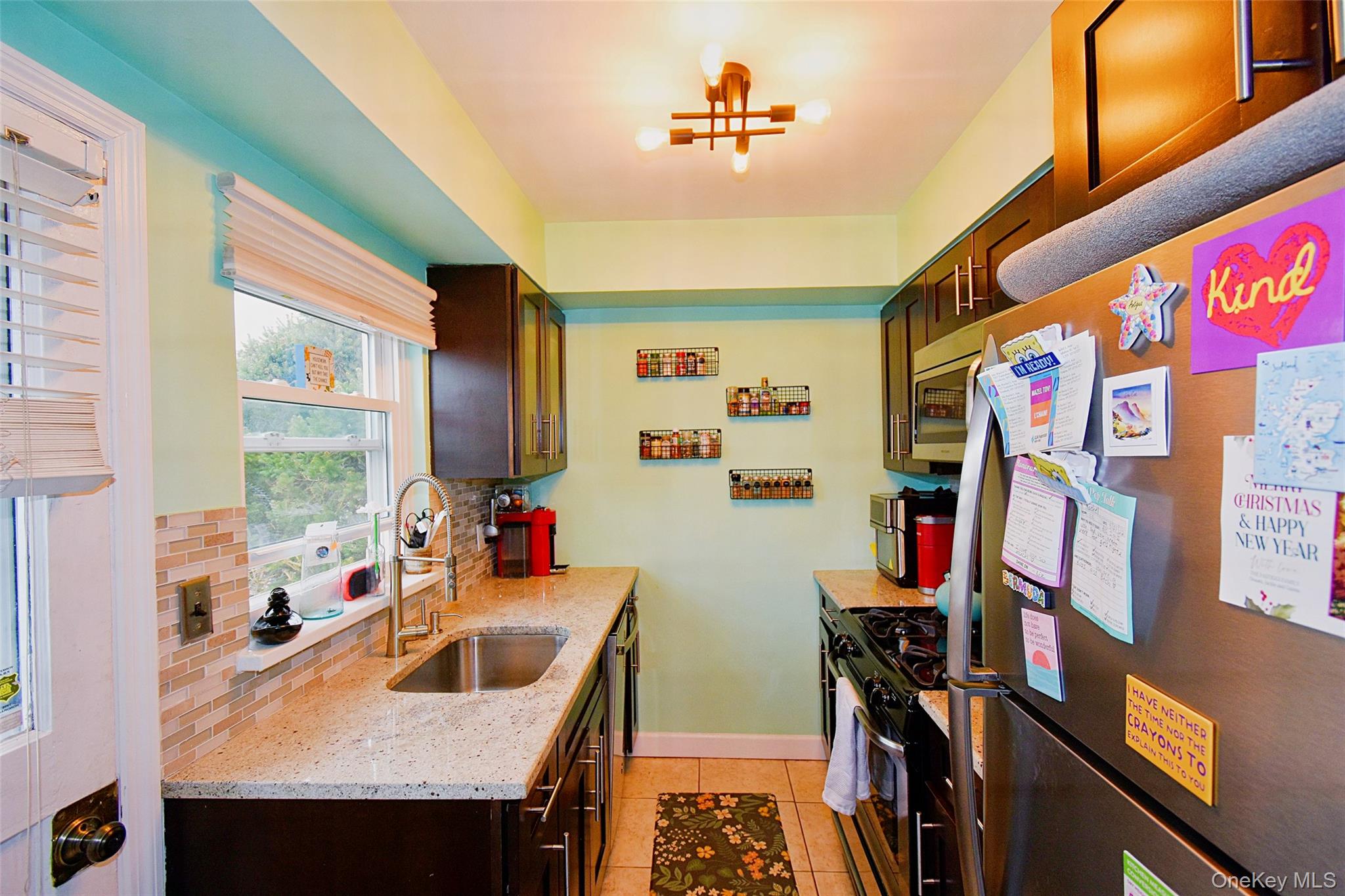 737 Tuckahoe Road, Unit 23 Yonkers, NY 10710 - Photo 7 of 12 a view of a kitchen with fridge and window