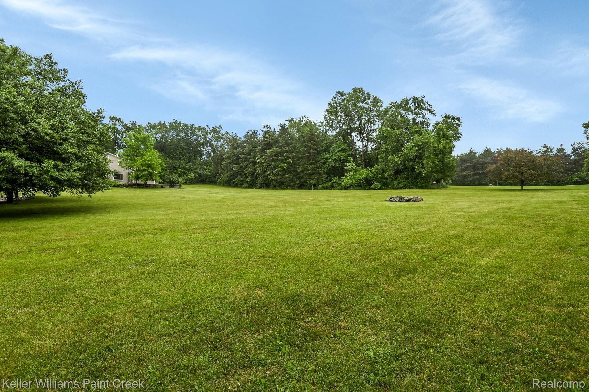 8179 Oakhill Road Clarkston, MI 48348 - Photo 24 of 38 Fire pit laid for additional outdoor living area.