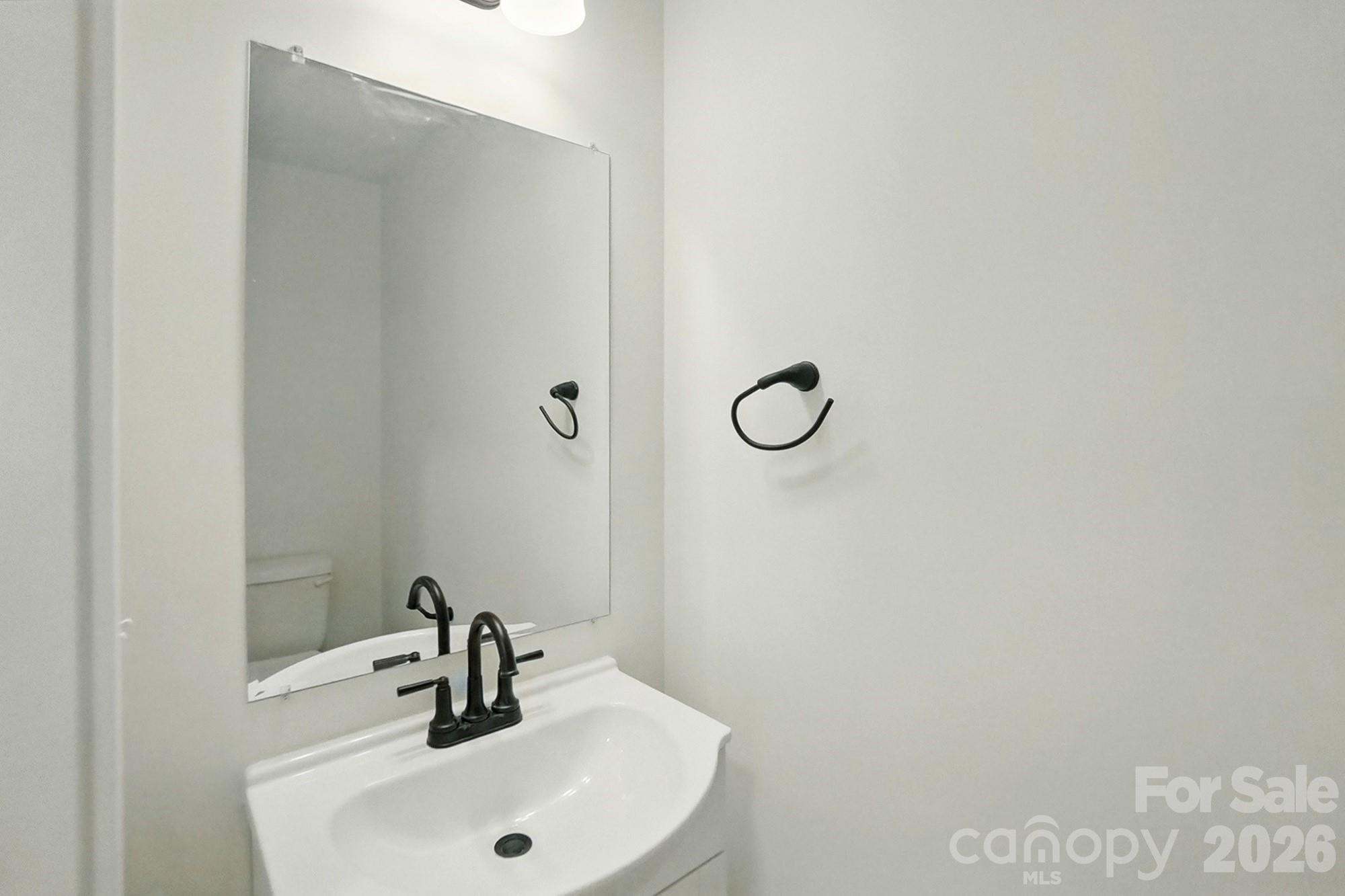 274 Bellhaven Place Northwest Concord, NC 28027 - Photo 14 of 27 a bathroom with a sink and a mirror