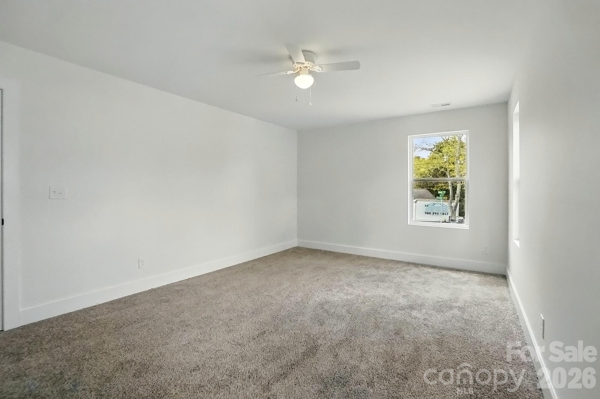 274 Bellhaven Place Northwest Concord, NC 28027 - Photo 18 of 27 an empty room with windows and fan