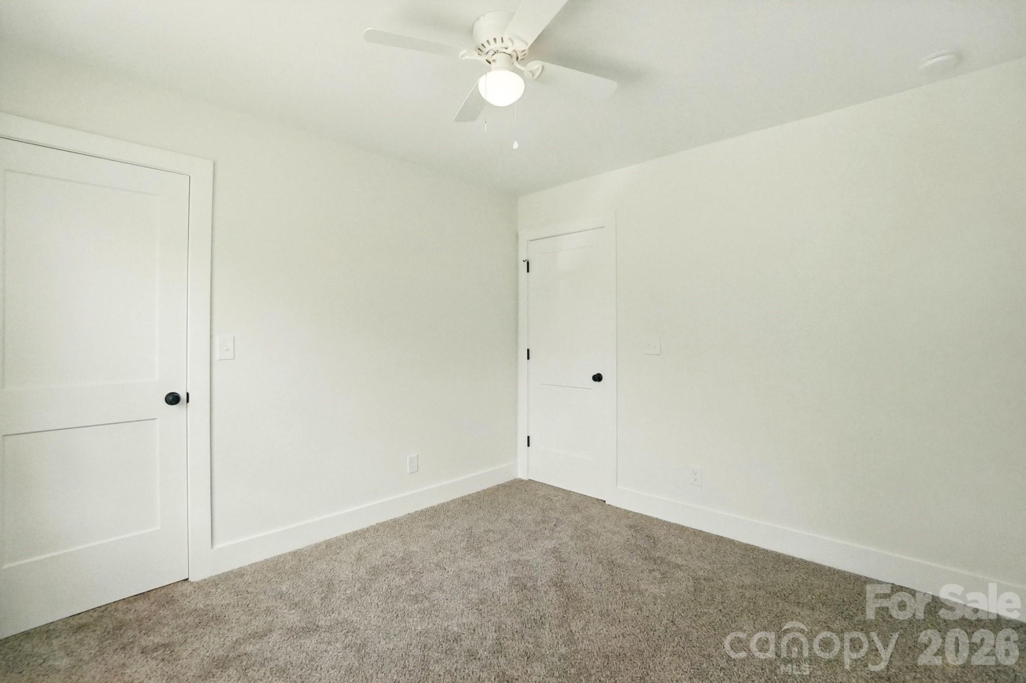 274 Bellhaven Place Northwest Concord, NC 28027 - Photo 23 of 27 an empty room with a ceiling fan and a window