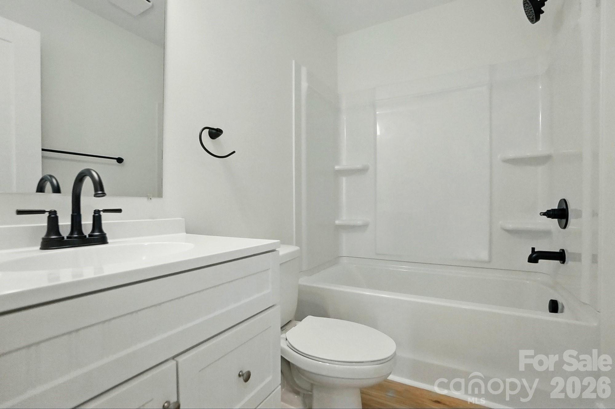 274 Bellhaven Place Northwest Concord, NC 28027 - Photo 24 of 27 a bathroom with a sink a toilet and a bathtub