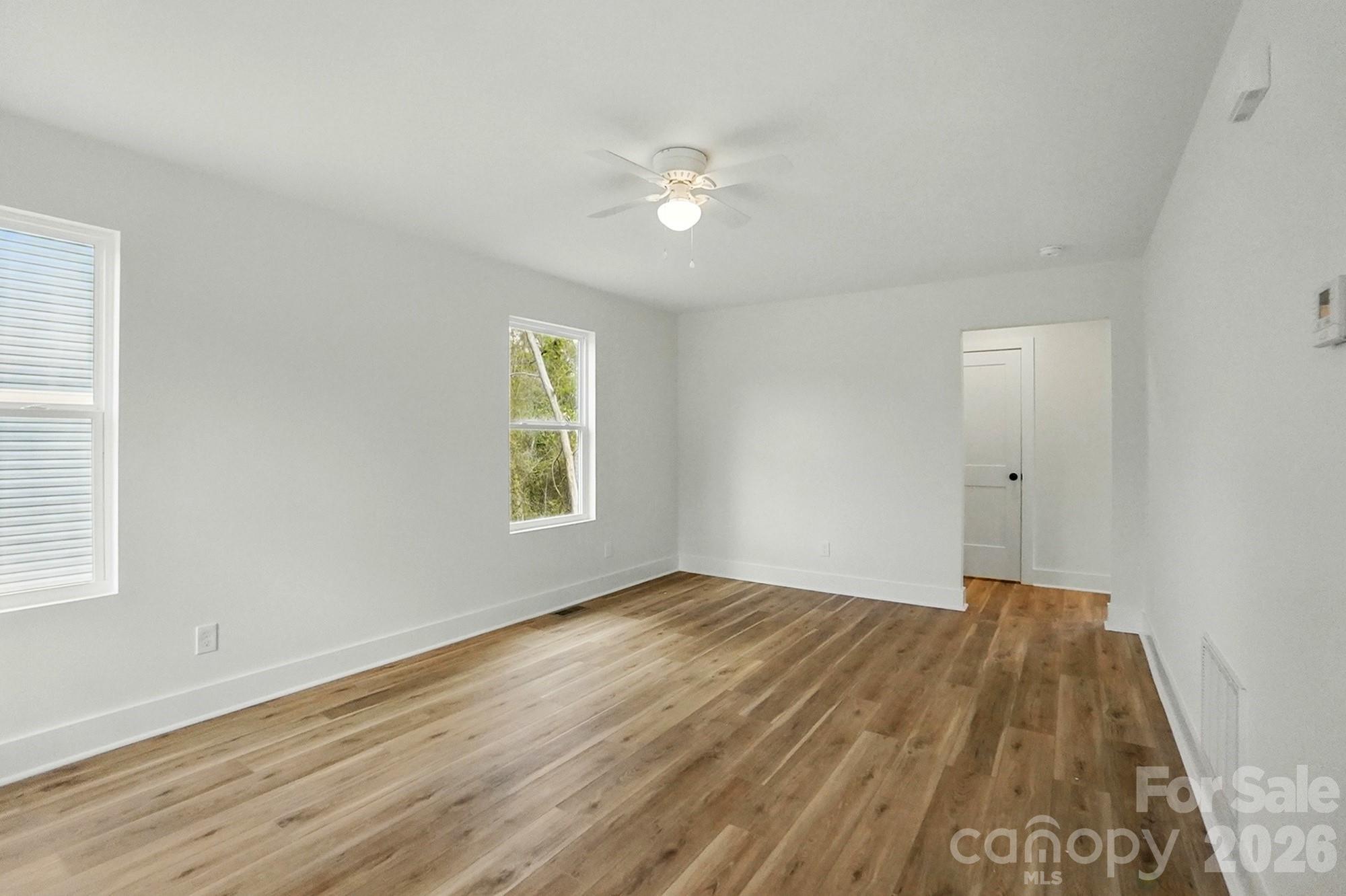 274 Bellhaven Place Northwest Concord, NC 28027 - Photo 3 of 27 a view of an empty room with wooden floor and a window