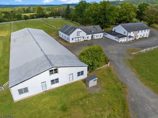 an aerial view of a house with garden space and lake view