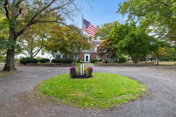 a front view of a house with a yard and car parked