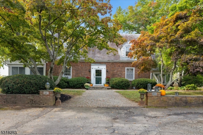 1850 Burnt Mills Road Bedminster, NJ 07921 - Photo 30 of 30 a front view of a house with a yard and car parked