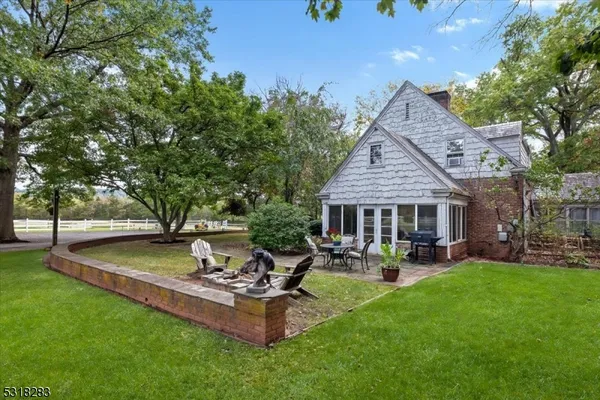 a view of a house with patio and a yard