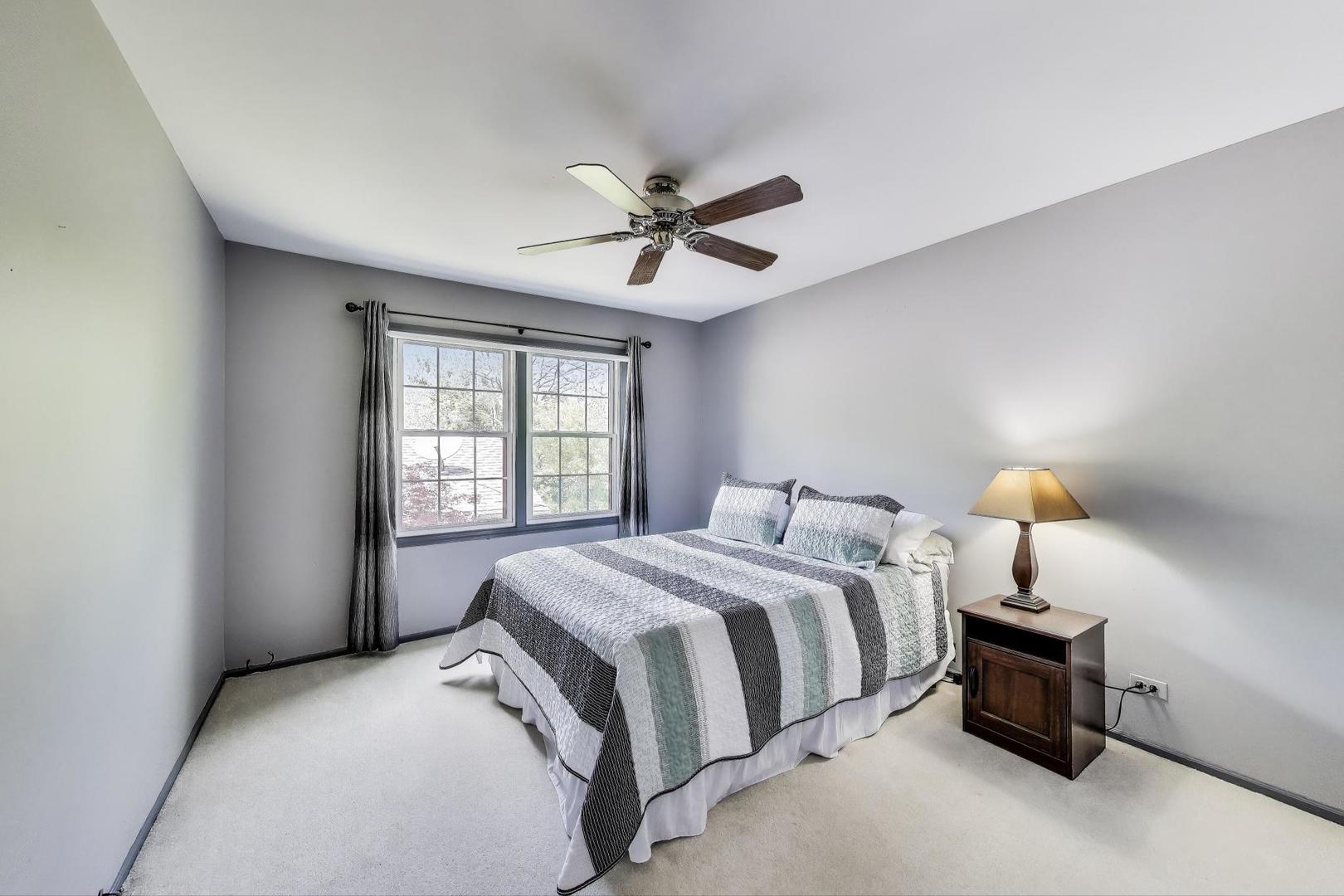 1022 Oakview Drive Wheaton, IL 60187 - Photo 11 of 20 a bedroom with a bed and a chandelier