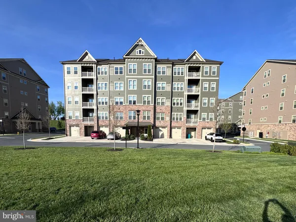 a front view of building with yard and green space
