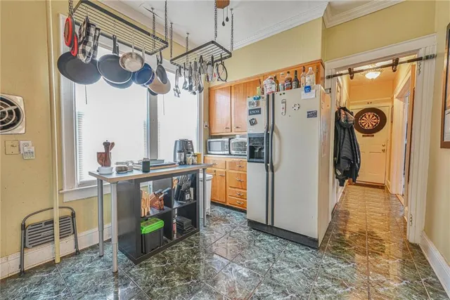 a kitchen with stainless steel appliances granite countertop a refrigerator and a stove