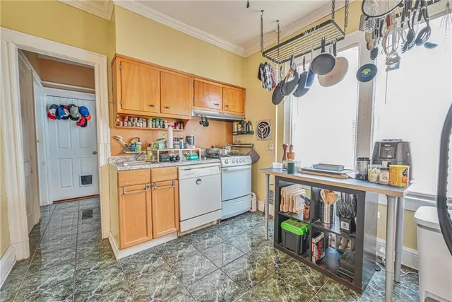 a kitchen with stainless steel appliances granite countertop a sink a stove a refrigerator and cabinets