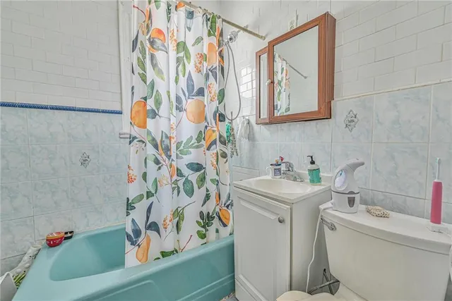 a bathroom with a sink and mirror with toilet