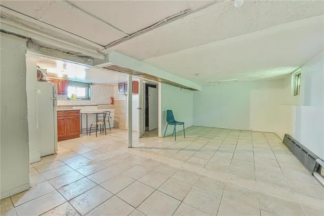 a view of a livingroom with a flesh screen tv and outdoor kitchen