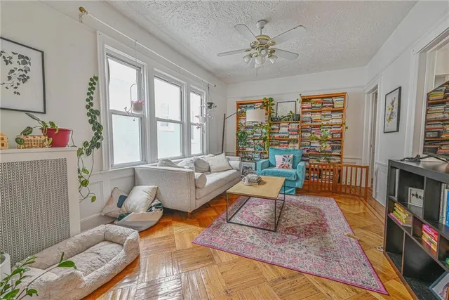 a living room with furniture large window and flat screen tv