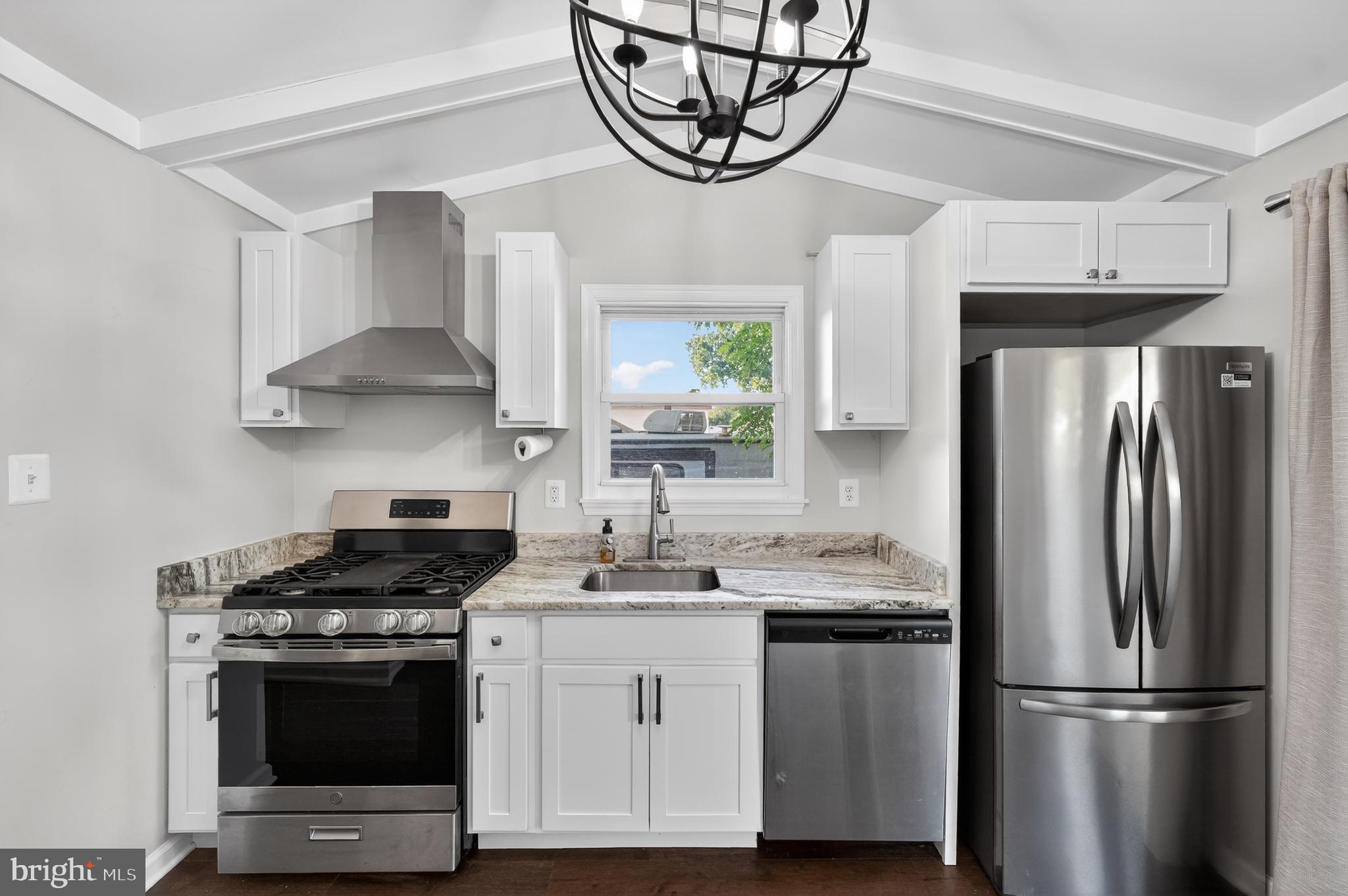 3670 5th Avenue Edgewater, MD 21037 - Photo 11 of 60 a kitchen with stainless steel appliances a stove a sink and a refrigerator
