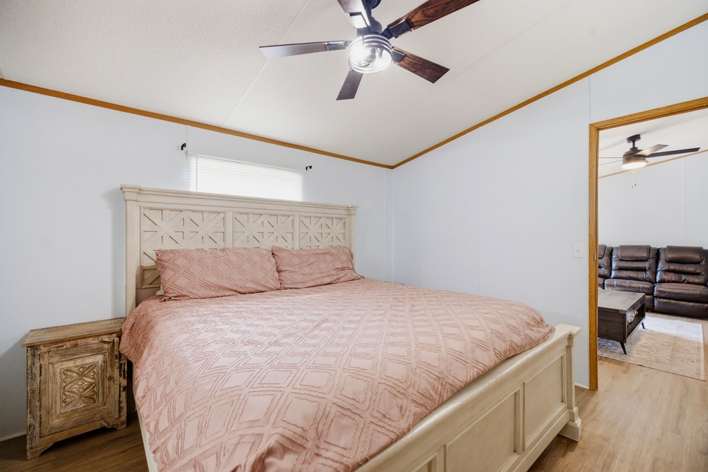 503 Whitten Road Waterloo, SC 29384 - Photo 11 of 31 a bedroom with a bed and a chandelier