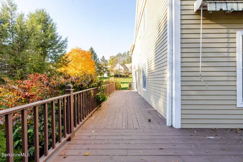 a view of a balcony with wooden floor and fence