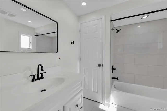 a bathroom with a sink a toilet and a bathtub