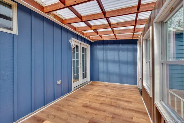 a view of a room with a wooden door
