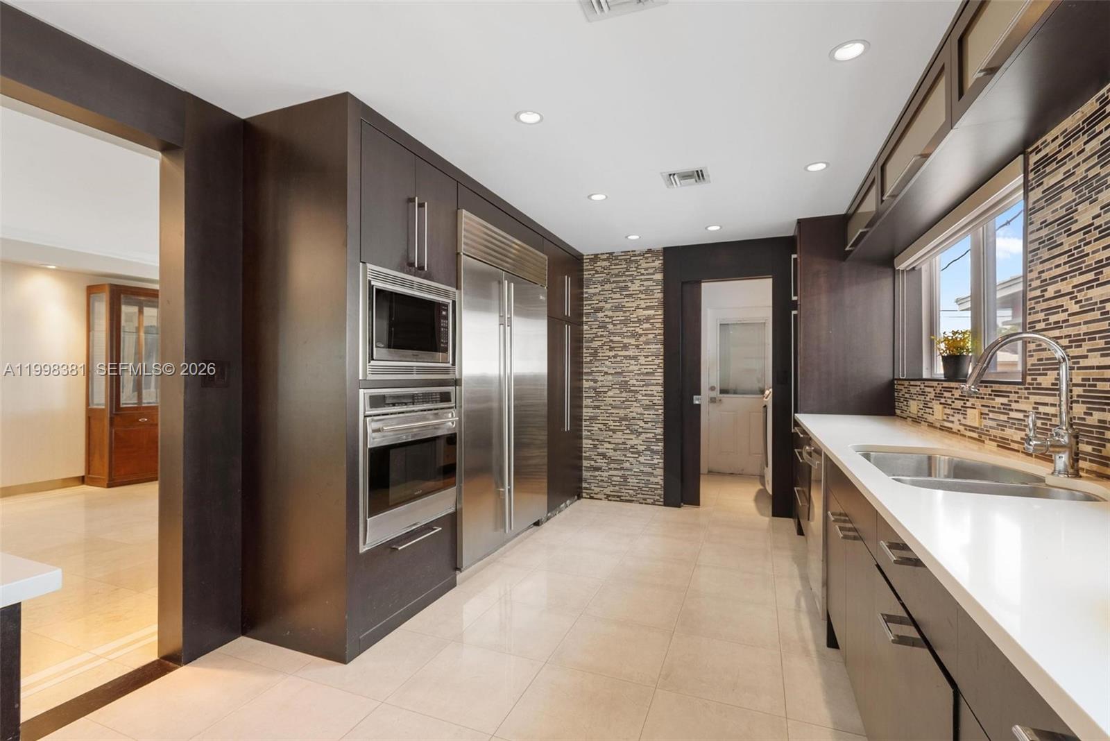 9141 Abbott Avenue Surfside, FL 33154 - Photo 12 of 31 a kitchen with stainless steel appliances granite countertop a refrigerator and a sink