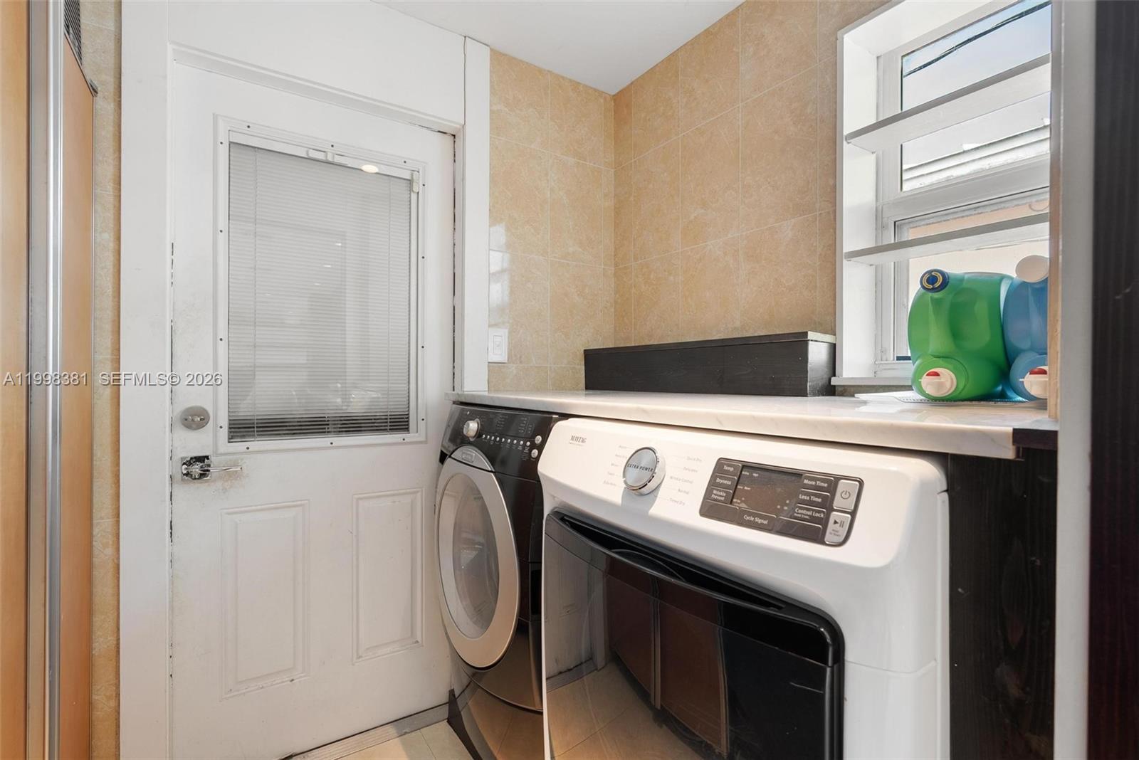 9141 Abbott Avenue Surfside, FL 33154 - Photo 13 of 31 a kitchen with a stove and a refrigerator
