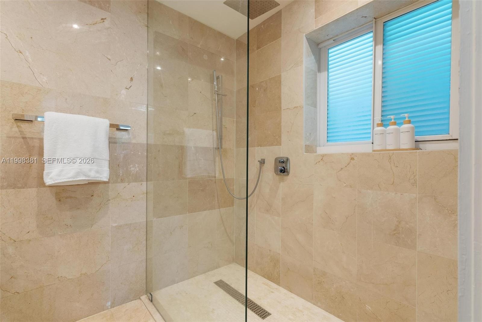 9141 Abbott Avenue Surfside, FL 33154 - Photo 17 of 31 a bathroom with a shower