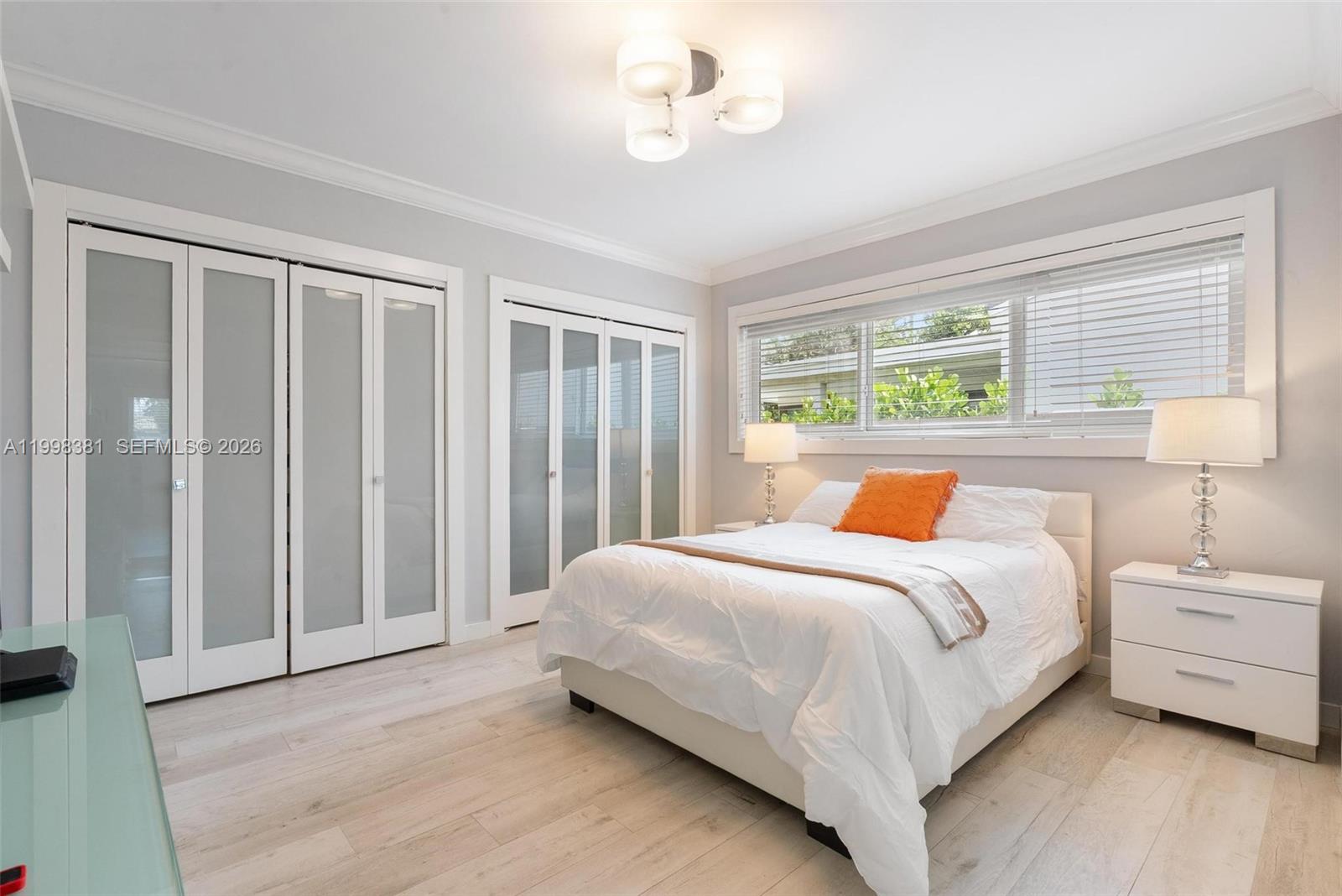 9141 Abbott Avenue Surfside, FL 33154 - Photo 20 of 31 a bedroom with a bed dresser and a window