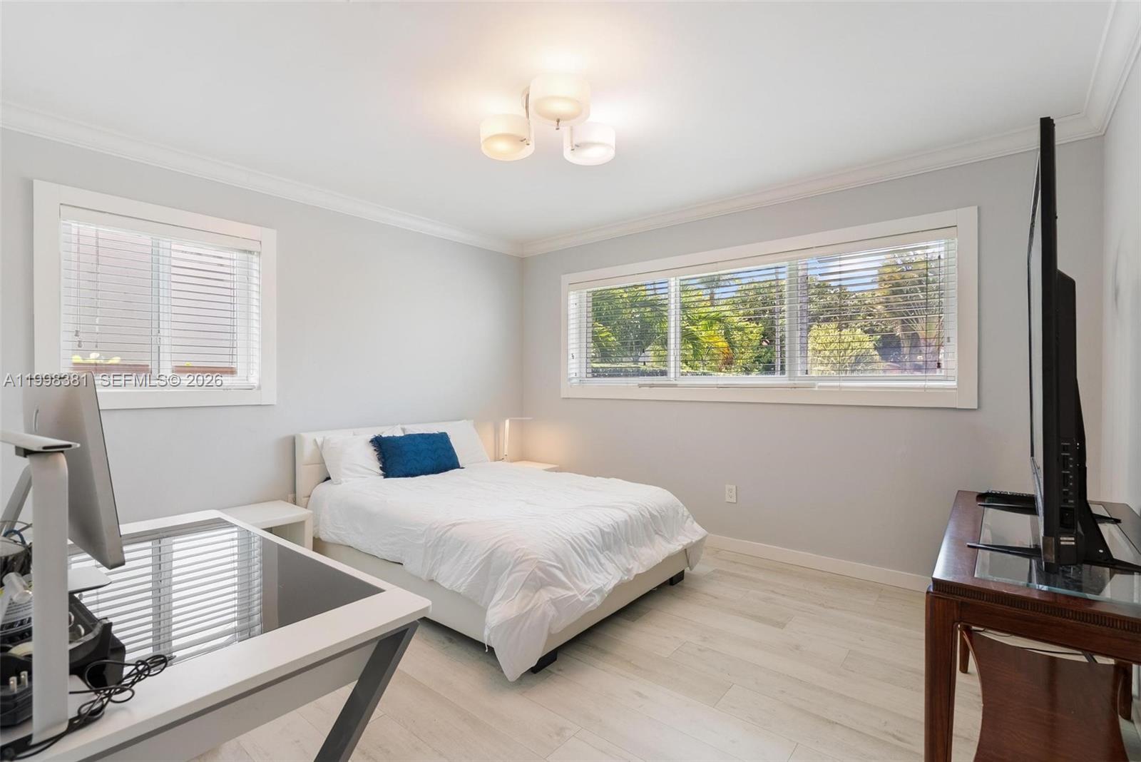 9141 Abbott Avenue Surfside, FL 33154 - Photo 21 of 31 a bedroom with a bed and a window