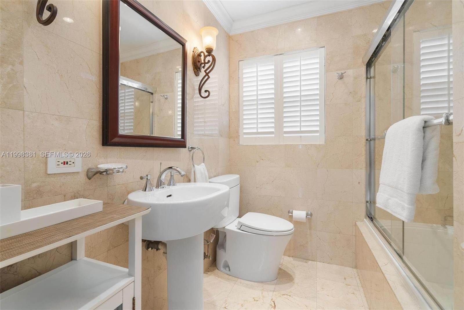 9141 Abbott Avenue Surfside, FL 33154 - Photo 22 of 31 a bathroom with a sink toilet and mirror
