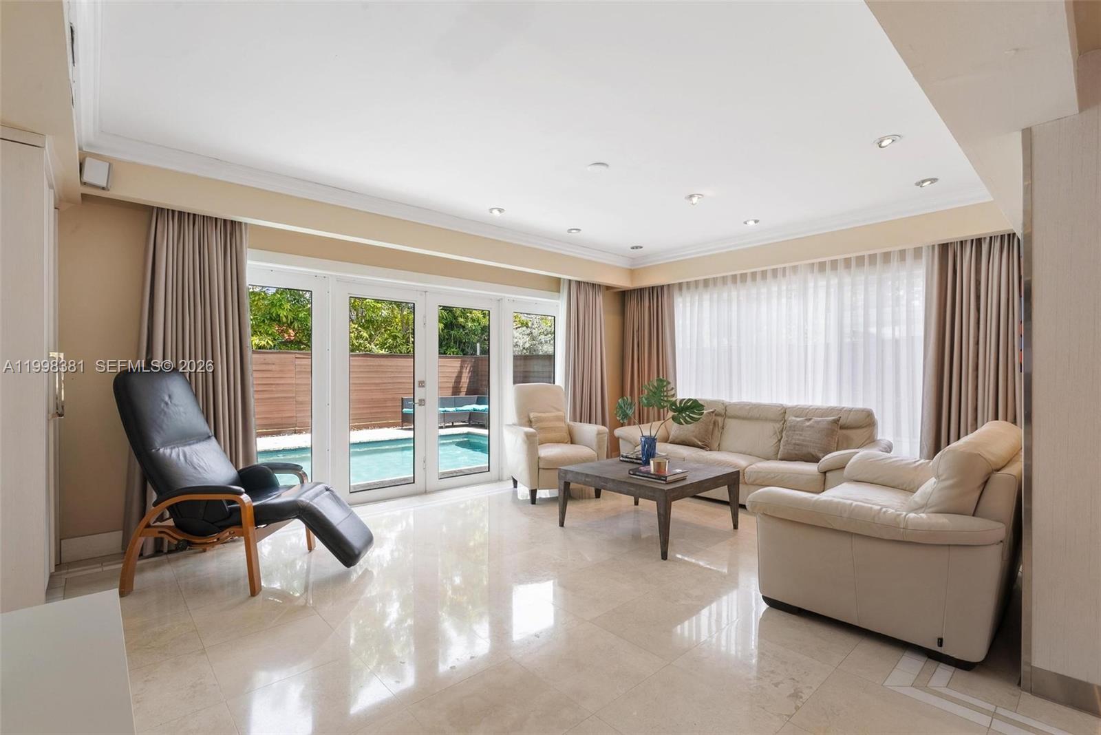 9141 Abbott Avenue Surfside, FL 33154 - Photo 3 of 31 a living room with furniture and a large window