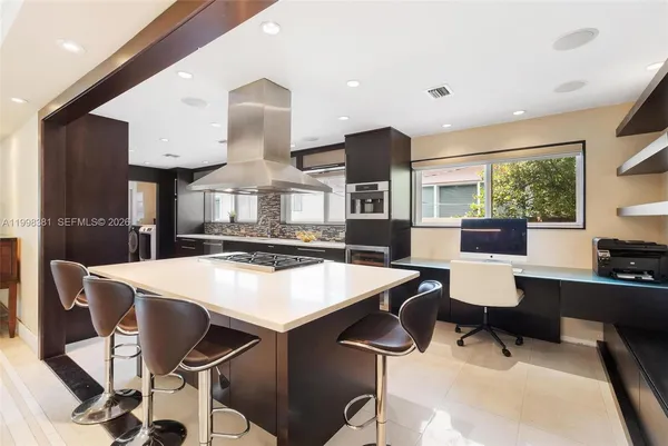 a kitchen with a dining table and chairs